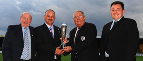 Ian Darler (2nd from left) receives his trophy from Maurice Armstrong of The FA Pitches and Facilities Committee.